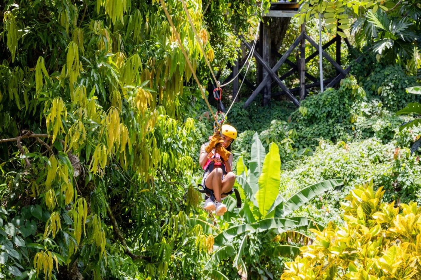 Femme en tyrolienne au-dessus de la forêt tropicale près de Punta Cana