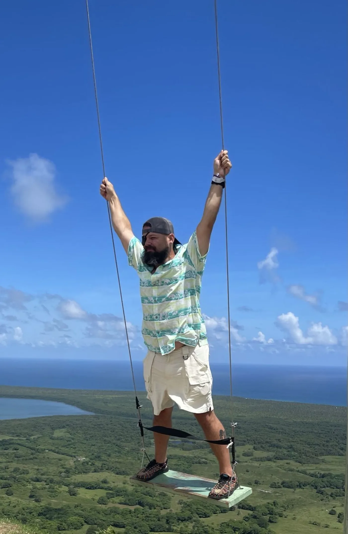 Traveler on the Montaña Redonda swing overlooking the lagoon, Miches