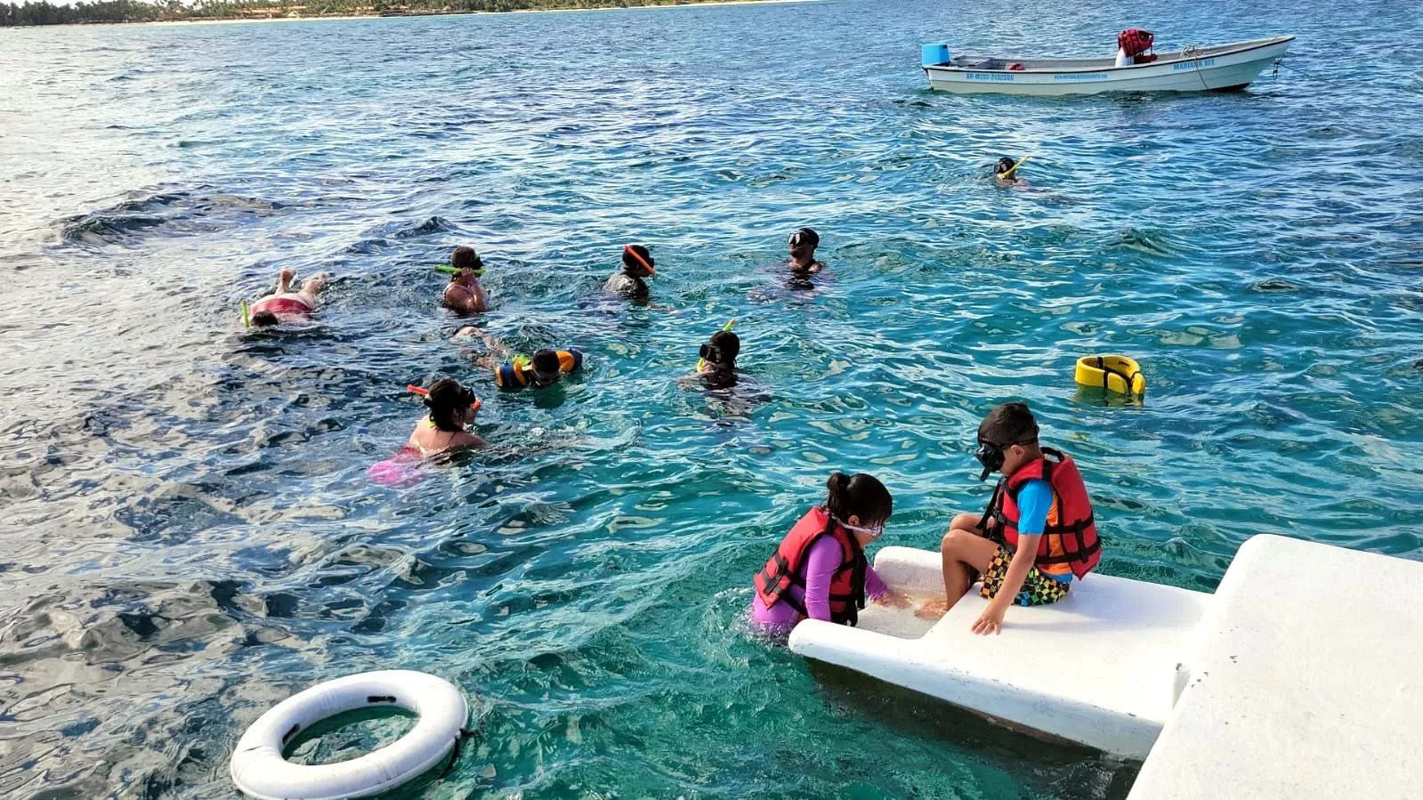 Happy group on the boat transfer to the Scuba Doo platform